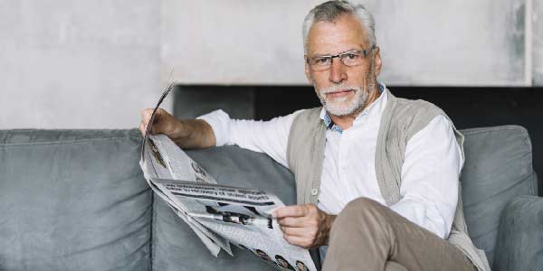 Middle aged man with glasses reading